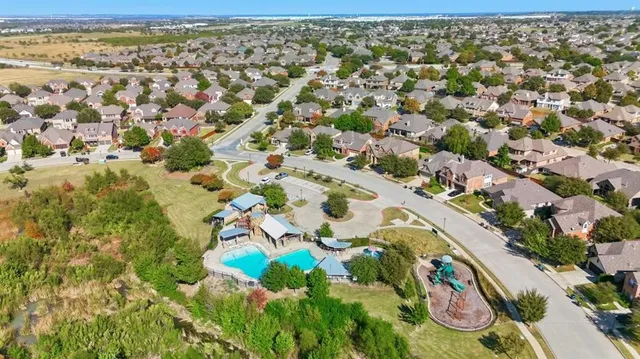 an aerial view of residential houses with outdoor space