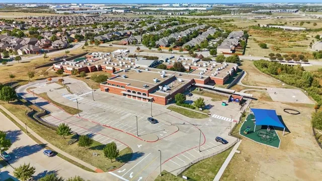 an aerial view of residential houses with outdoor space
