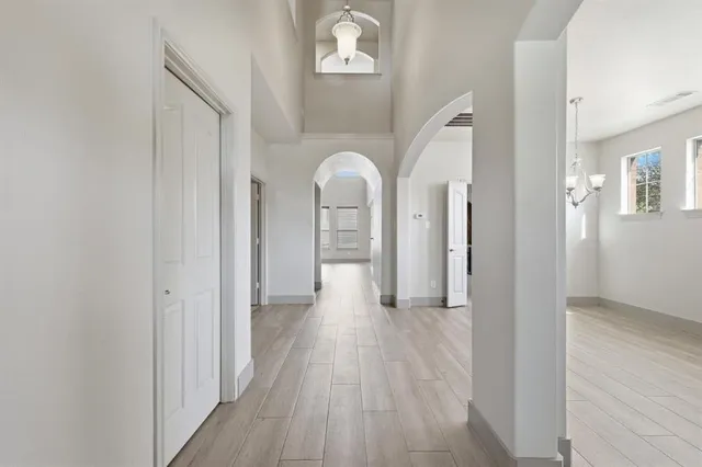 a view of a hallway with wooden floor