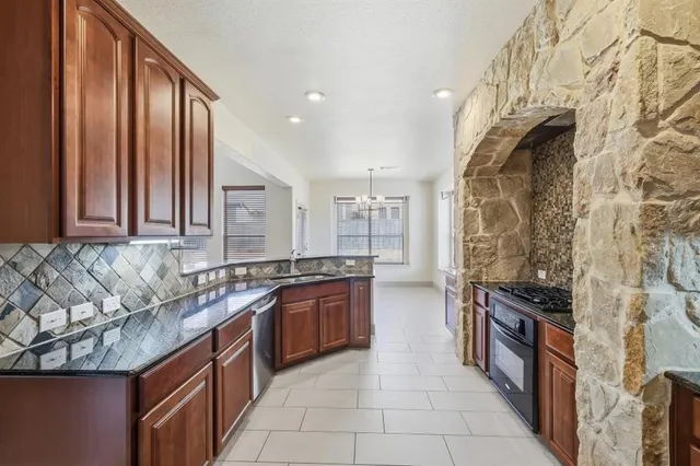 a kitchen with stainless steel appliances granite countertop a stove and a sink