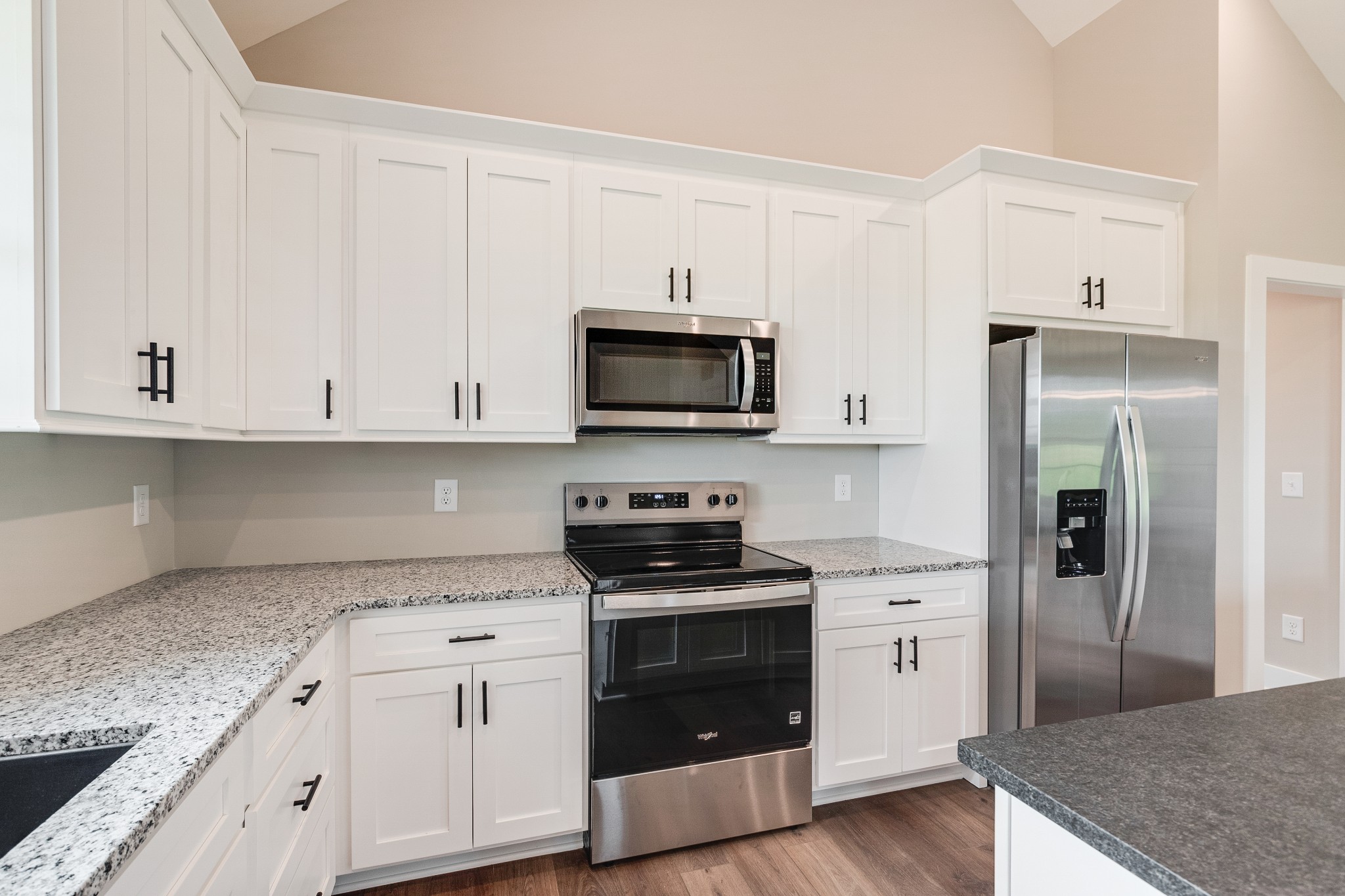 928 Butler Bridge Road Portland, TN 37148 - Photo 12 of 26 a kitchen with granite countertop white cabinets and black appliances