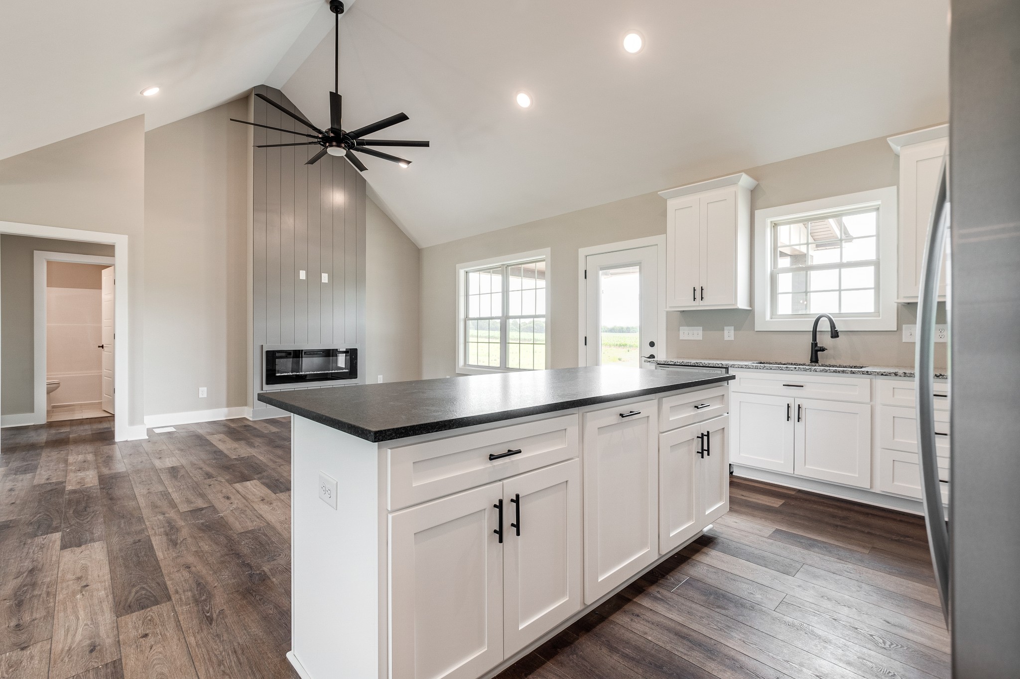 928 Butler Bridge Road Portland, TN 37148 - Photo 13 of 26 a kitchen with granite countertop a sink cabinets appliances and a window