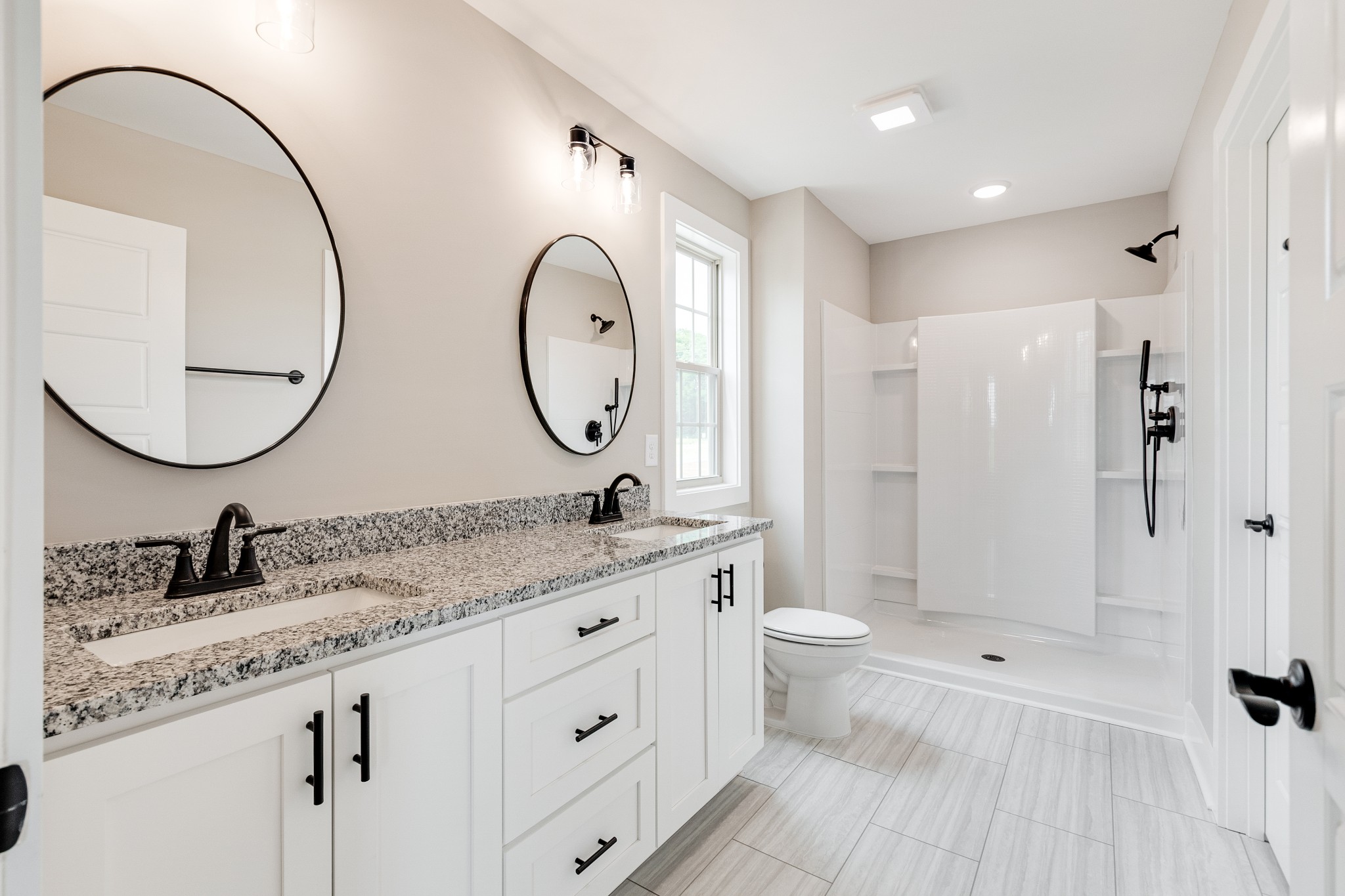 928 Butler Bridge Road Portland, TN 37148 - Photo 17 of 26 a bathroom with a double vanity sink and a mirror