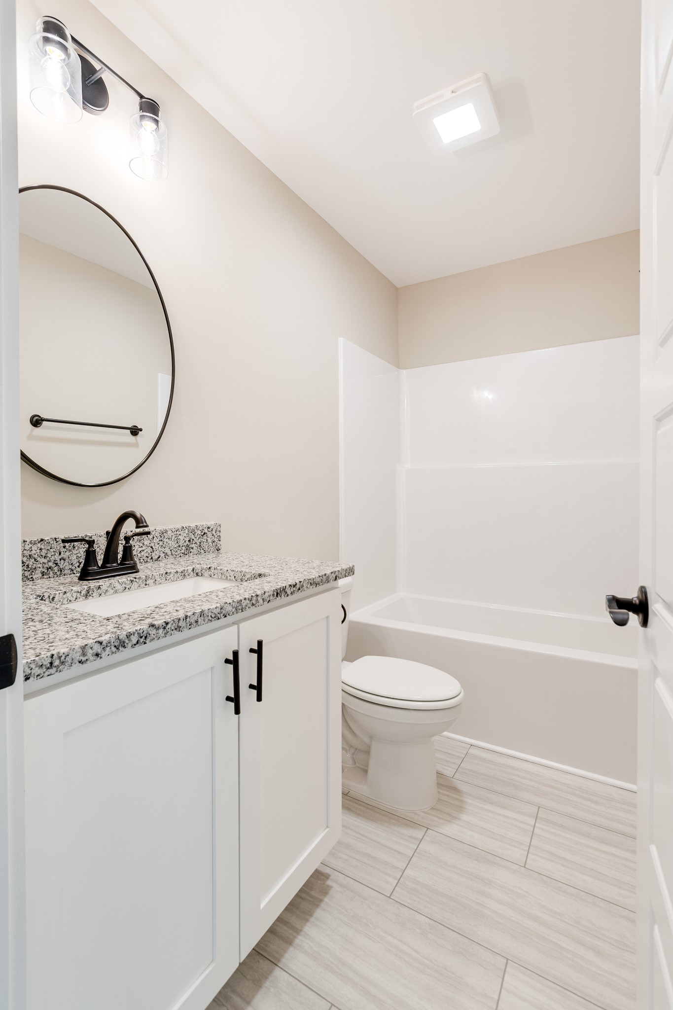 928 Butler Bridge Road Portland, TN 37148 - Photo 22 of 26 a bathroom with a granite countertop toilet a sink and a mirror