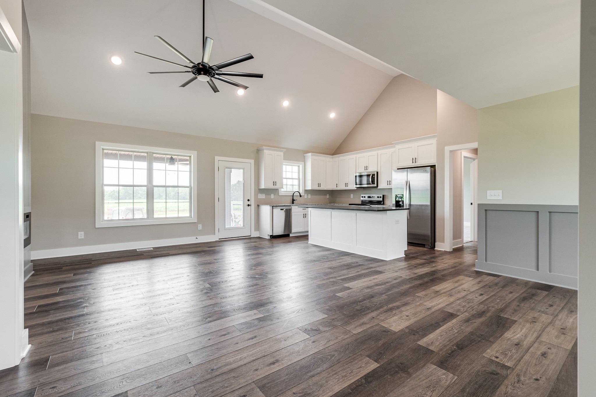928 Butler Bridge Road Portland, TN 37148 - Photo 4 of 26 a view of a kitchen with a sink refrigerator a ceiling fan and wooden floor