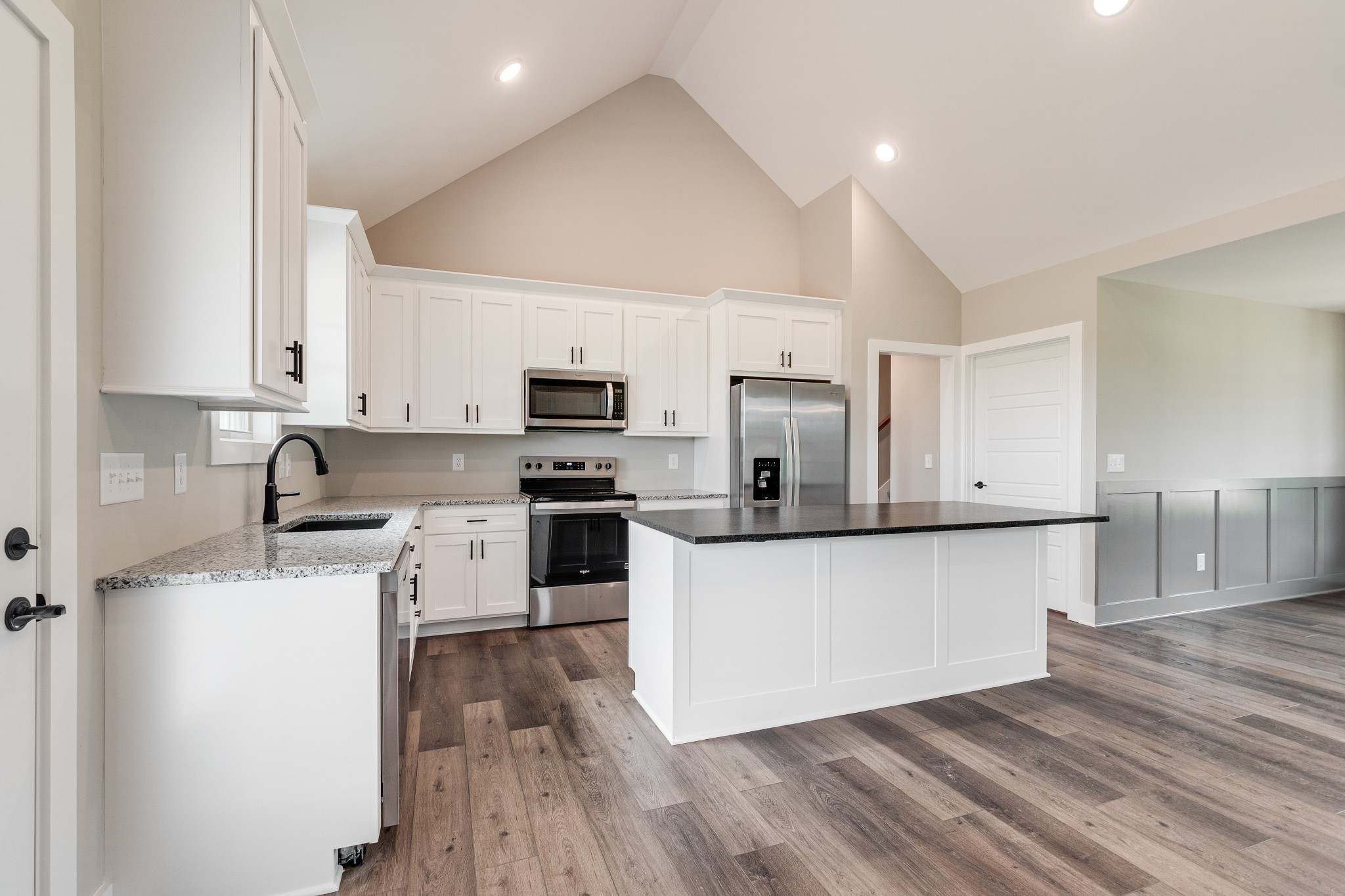 928 Butler Bridge Road Portland, TN 37148 - Photo 8 of 26 a kitchen with stainless steel appliances a stove top oven a sink and white cabinets