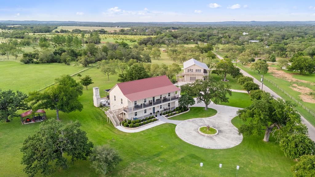 an aerial view of a house with yard swimming pool and outdoor seating