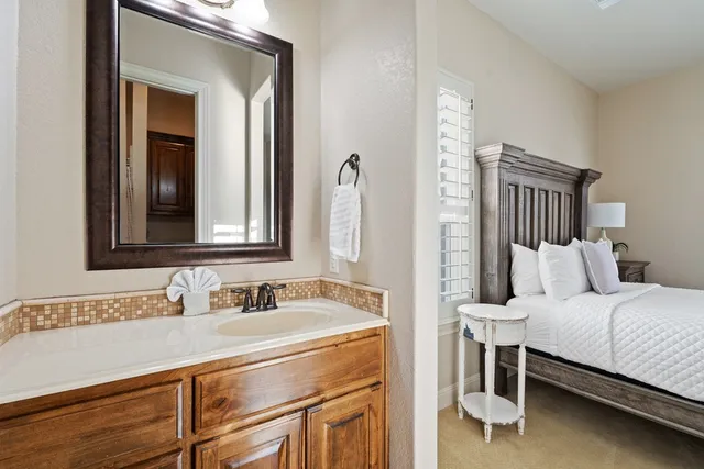 a en suite bathroom with a sink and a mirror
