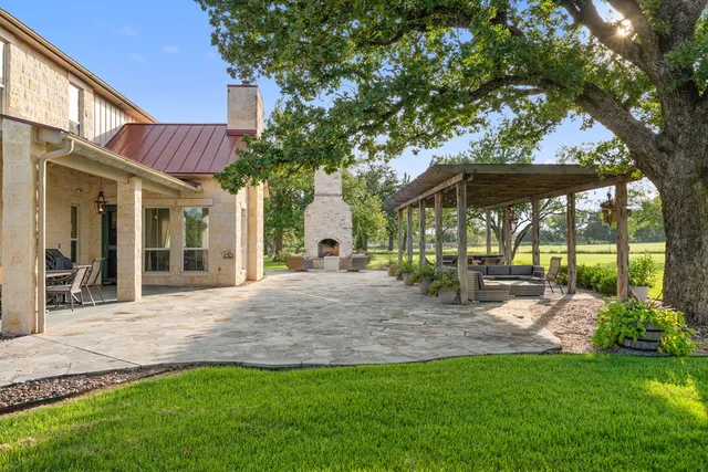 a view of a house with backyard porch and sitting area