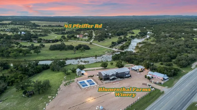 an aerial view of residential houses with outdoor space and street view