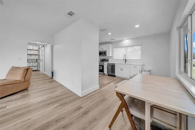 a open kitchen with cabinets table and chairs