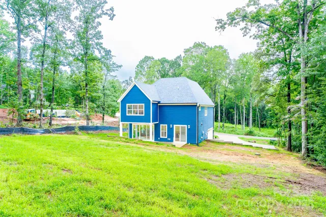 a bathroom with a double vanity sink toilet mirror and bathtub