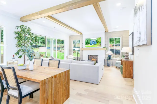 a living room with furniture a large window and a fireplace