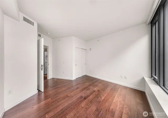 a spacious bathroom with a granite countertop sink mirror and a shower