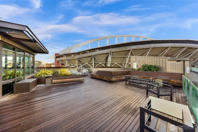 a view of a balcony with wooden floor and outdoor seating
