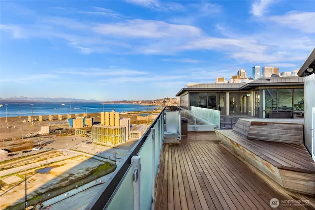 a view of roof deck with two couches and wooden floor