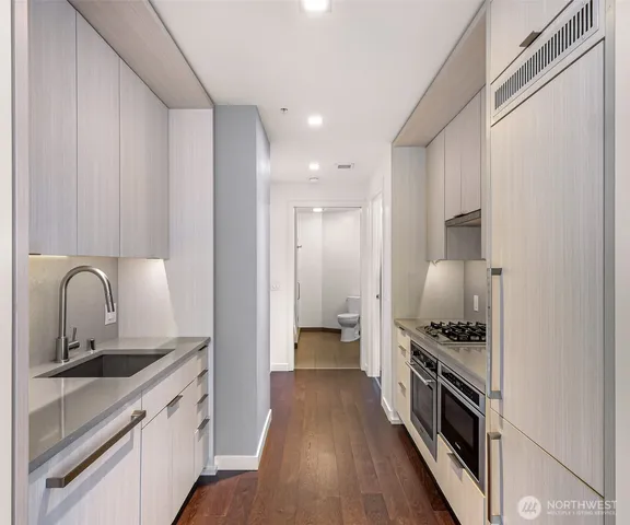 a kitchen with a stove and white cabinets