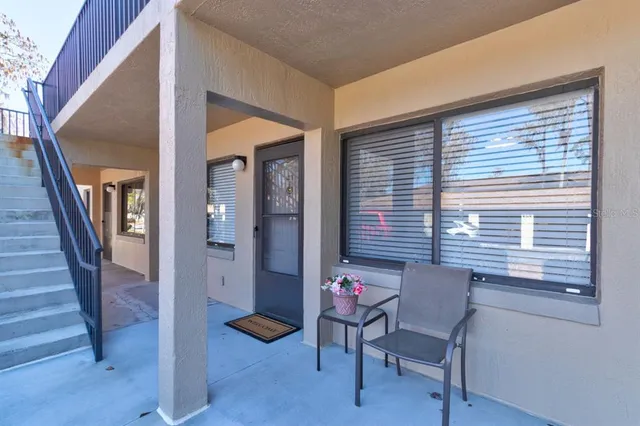 a view of a livingroom with furniture and stairs