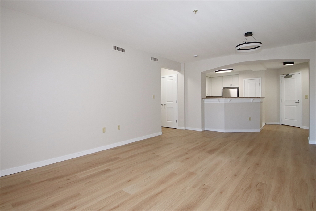 175 Cottage Street, Unit 501 Chelsea, MA 02150 - Photo 14 of 42 a view of empty room with wooden floor