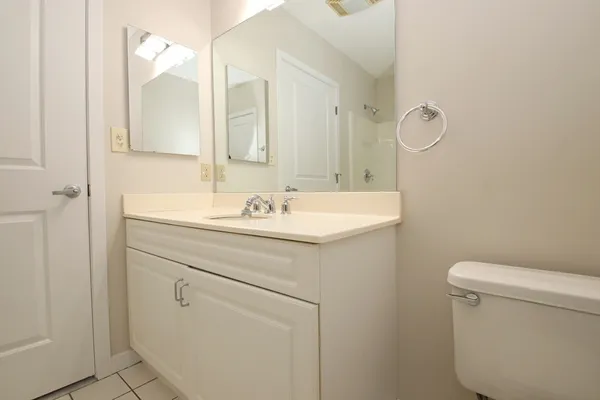 a bathroom with a sink a toilet and a mirror
