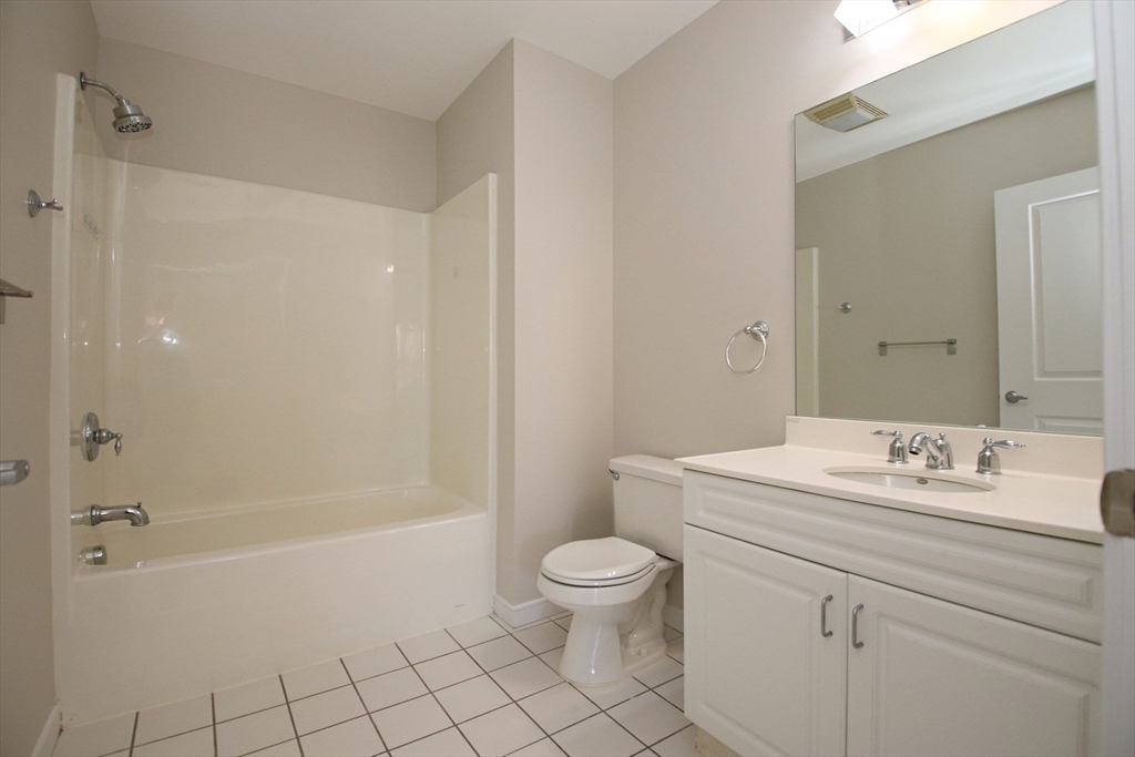 175 Cottage Street, Unit 501 Chelsea, MA 02150 - Photo 30 of 42 a bathroom with a sink a toilet and shower