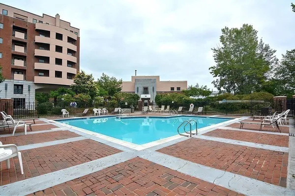 a view of a swimming pool with a bench