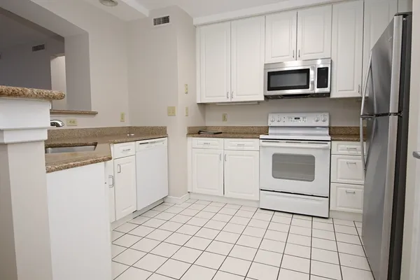 a kitchen with a stove sink and microwave