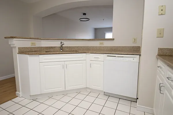 a view of a kitchen with white cabinets