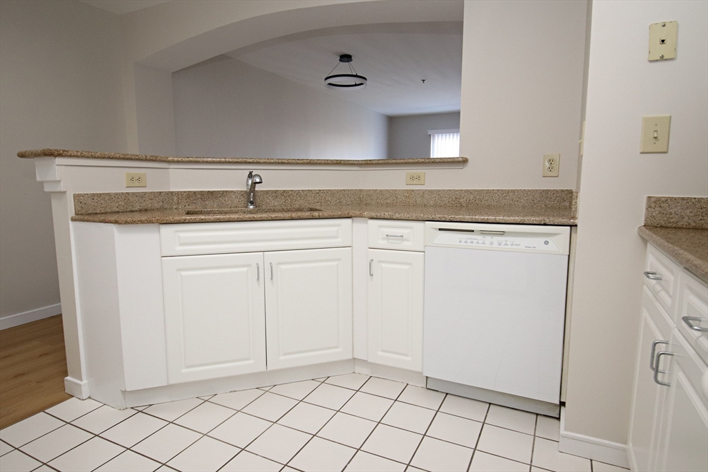 175 Cottage Street, Unit 501 Chelsea, MA 02150 - Photo 8 of 42 a view of a kitchen with white cabinets