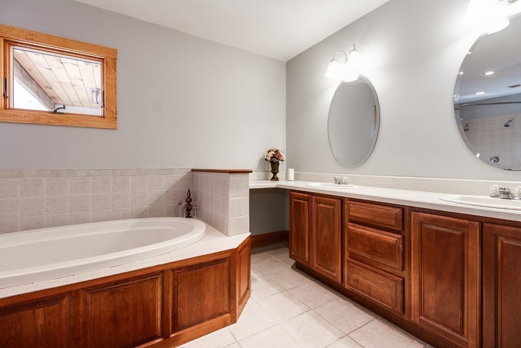 67 Campbell Street Rutland, MA 01543 - Photo 16 of 30 a bathroom with a double vanity sink mirror and bathtub