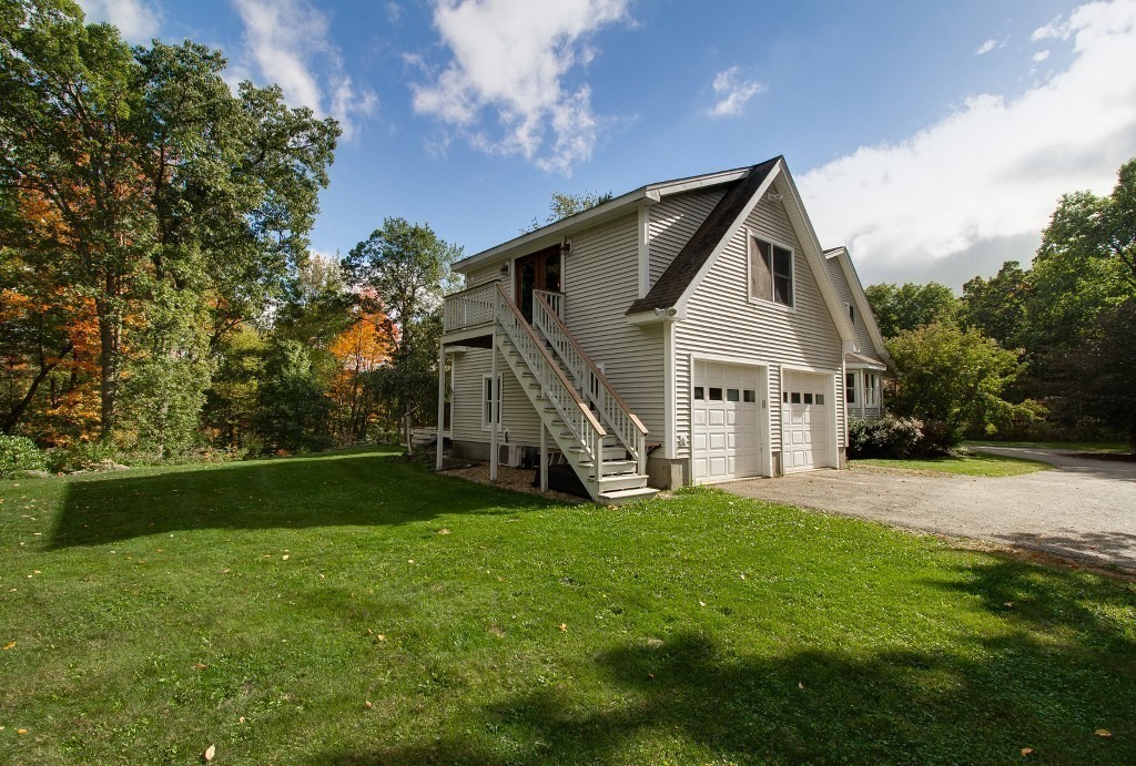 67 Campbell Street Rutland, MA 01543 - Photo 3 of 30 a view of a house with a big yard and large trees