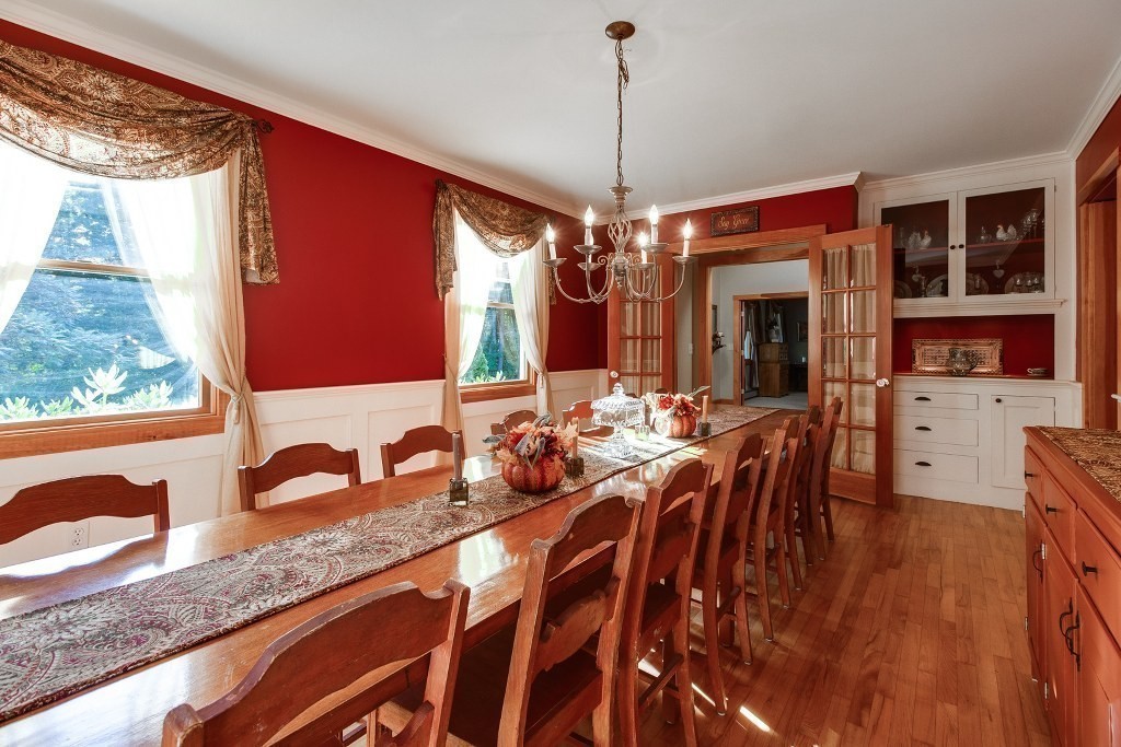 67 Campbell Street Rutland, MA 01543 - Photo 7 of 30 a view of a dining room and livingroom with furniture wooden floor a rug a potted plant and a chandelier