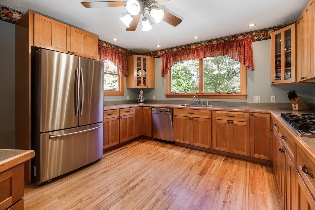 67 Campbell Street Rutland, MA 01543 - Photo 9 of 30 a kitchen with stainless steel appliances granite countertop a refrigerator a sink dishwasher a stove and white countertops with wooden floor