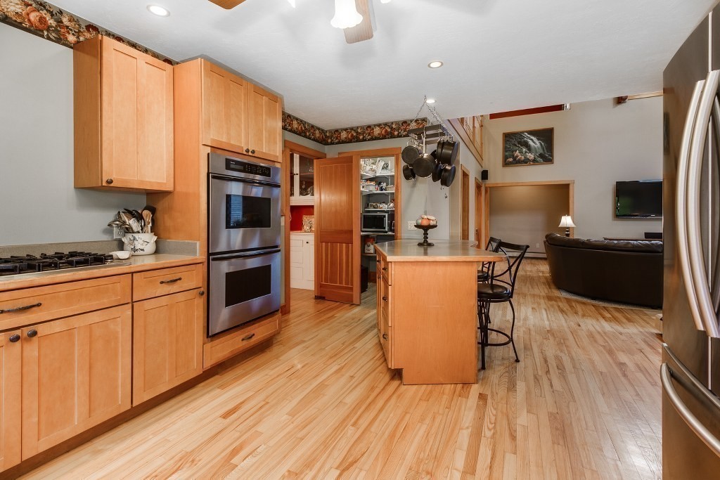 67 Campbell Street Rutland, MA 01543 - Photo 10 of 30 a kitchen with stainless steel appliances granite countertop a refrigerator a stove top oven a sink dishwasher and wooden cabinets with wooden floor