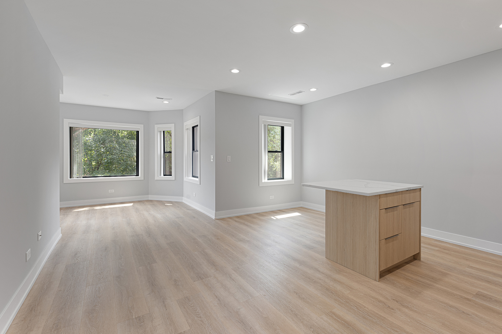 1548 West Juneway Terrace, Unit 2A Chicago, IL 60626 - Photo 2 of 18 a view of an empty room with wooden floor and a window