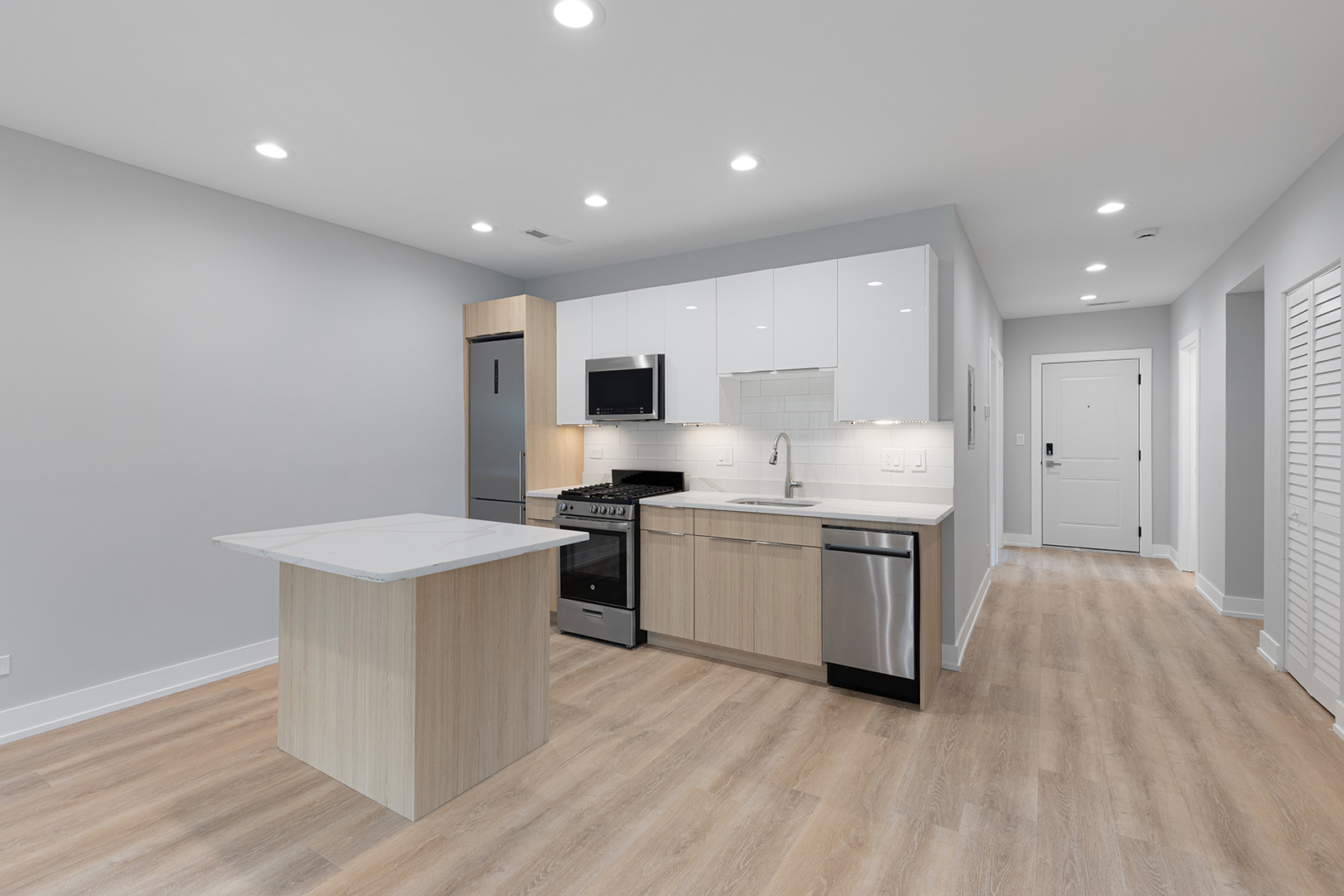 1548 West Juneway Terrace, Unit 2A Chicago, IL 60626 - Photo 3 of 18 a kitchen with a sink white cabinets and stainless steel appliances
