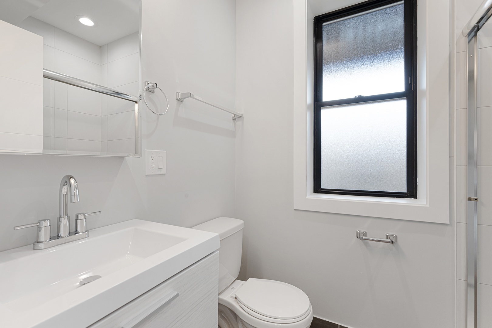 1548 West Juneway Terrace, Unit 2A Chicago, IL 60626 - Photo 9 of 18 a bathroom with a sink toilet and vanity