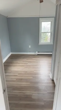a view of a room with window and hardwood floor