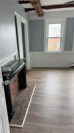 a living room with a fireplace furniture and a window