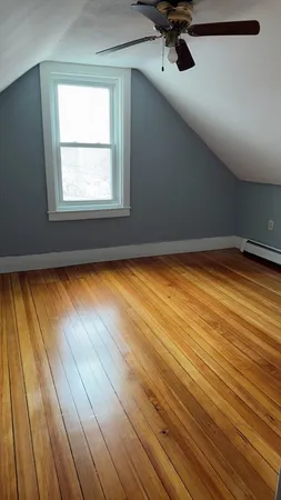 a view of a room with wooden floor and a window