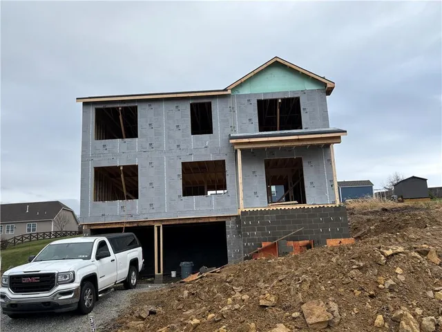 a front view of a house with parking space