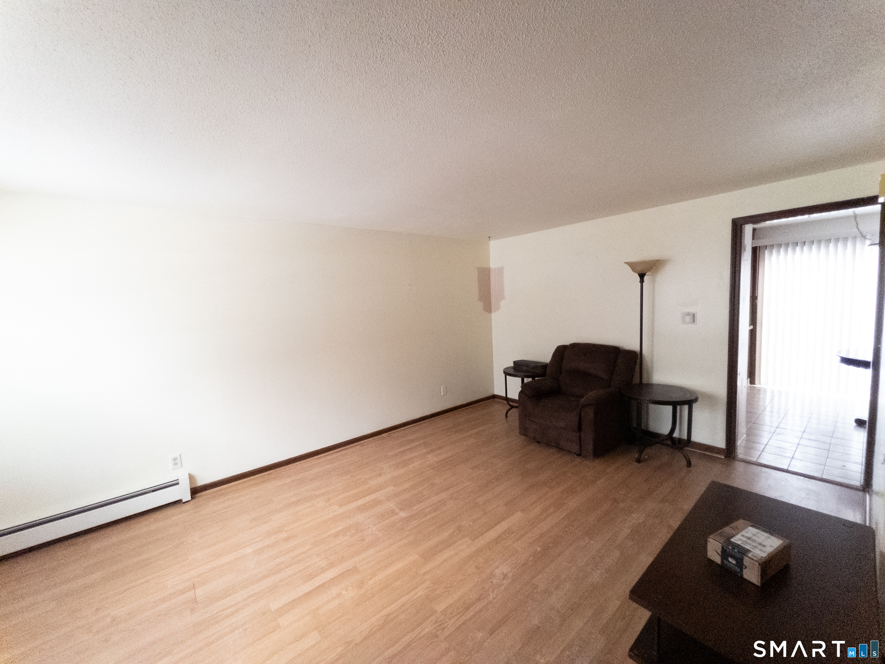 40 Grove Street, Unit B Manchester, CT 06042 - Photo 6 of 13 an empty room with furniture and wooden floor