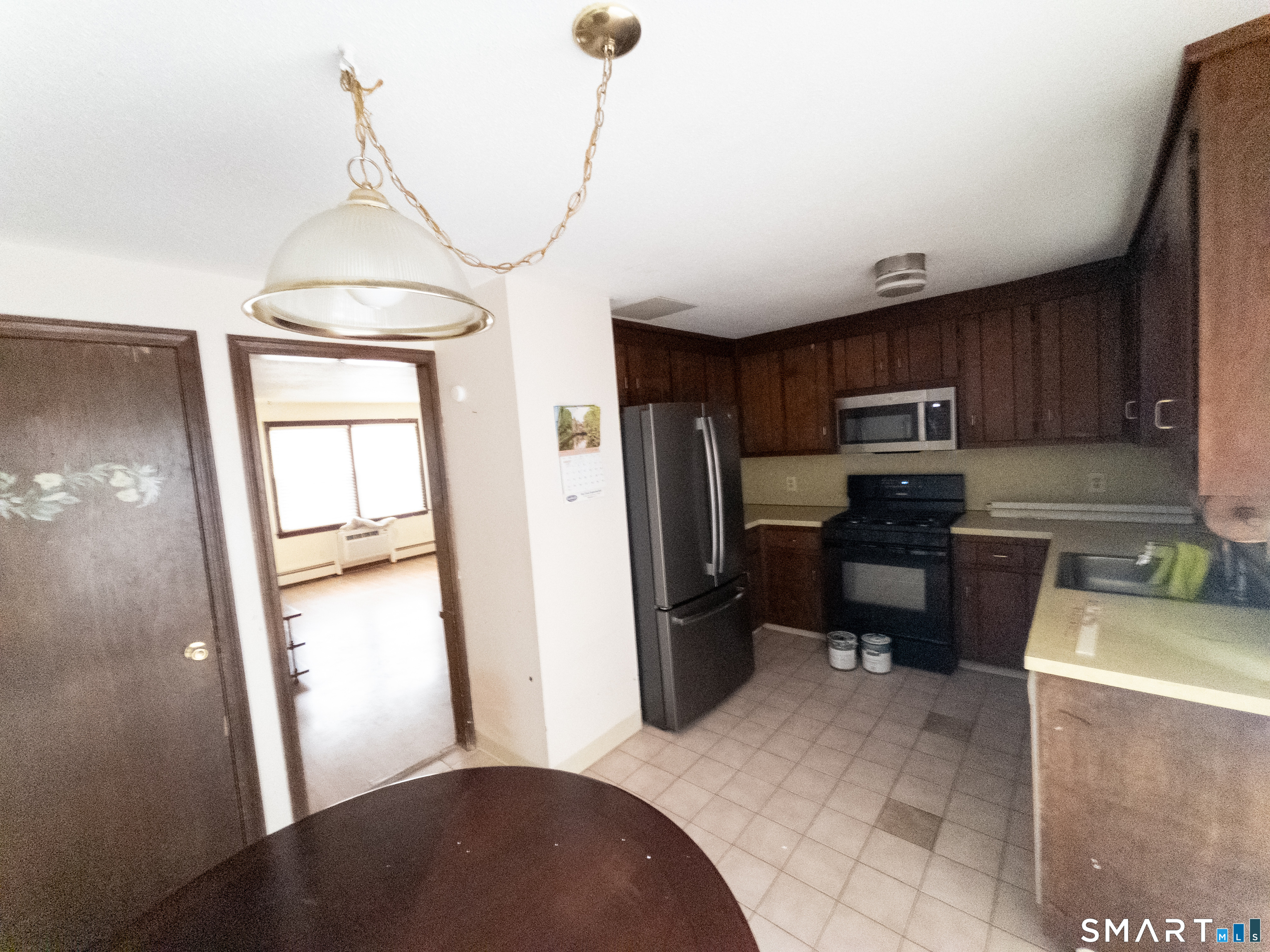 40 Grove Street, Unit B Manchester, CT 06042 - Photo 9 of 13 a kitchen with refrigerator a microwave a sink and a stove