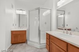 7701 West Robindale Road, Unit 277 Las Vegas, NV 89113 - Photo 15 of 33 Dual vanities and a glass-enclosed shower create a practical bathroom retreat.
