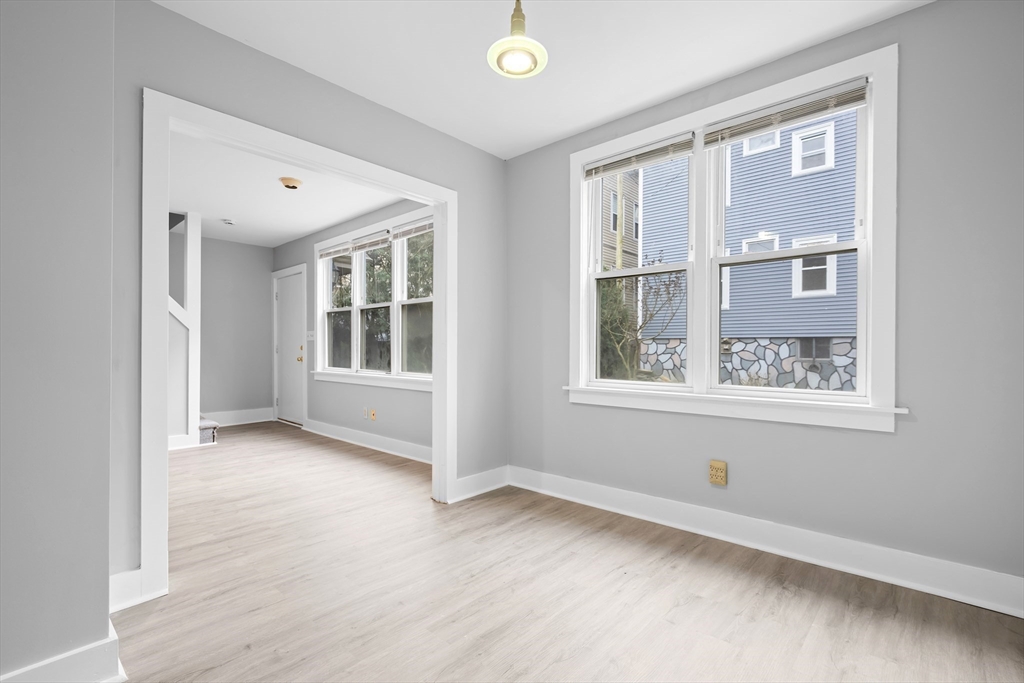 572 William Street Fall River, MA 02721 - Photo 11 of 31 a view of an empty room with a window and wooden floor