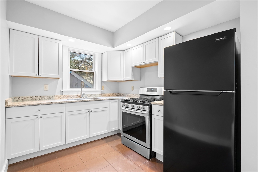 572 William Street Fall River, MA 02721 - Photo 12 of 31 a kitchen with granite countertop appliances cabinets and a sink