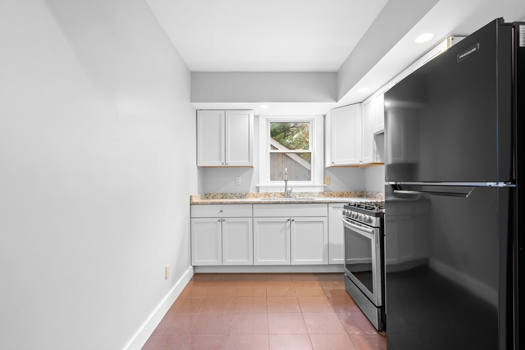 572 William Street Fall River, MA 02721 - Photo 13 of 31 a kitchen with granite countertop cabinets stainless steel appliances a sink and a window