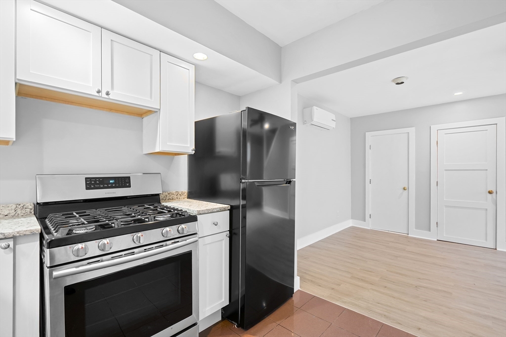 572 William Street Fall River, MA 02721 - Photo 14 of 31 a kitchen with stainless steel appliances granite countertop a refrigerator stove and cabinets