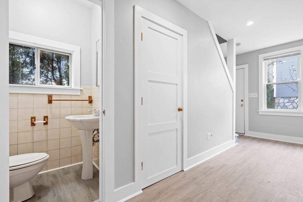 572 William Street Fall River, MA 02721 - Photo 15 of 31 a bathroom with a granite countertop toilet a sink and a window