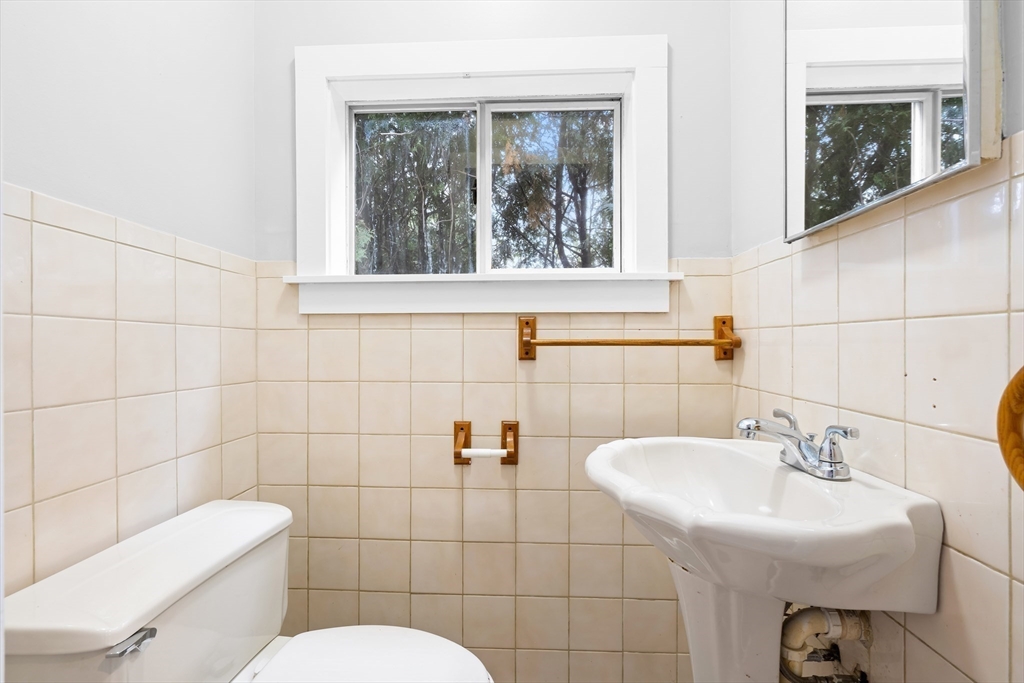 572 William Street Fall River, MA 02721 - Photo 16 of 31 a bathroom with a sink toilet and a mirror